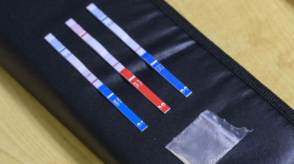 Tests strips used to detect the presence of fentanyl and xylazine lay next to a bag of heroin at St. Ann's Corner of Harm Reduction in New York, U.S., June 2023. /AFP