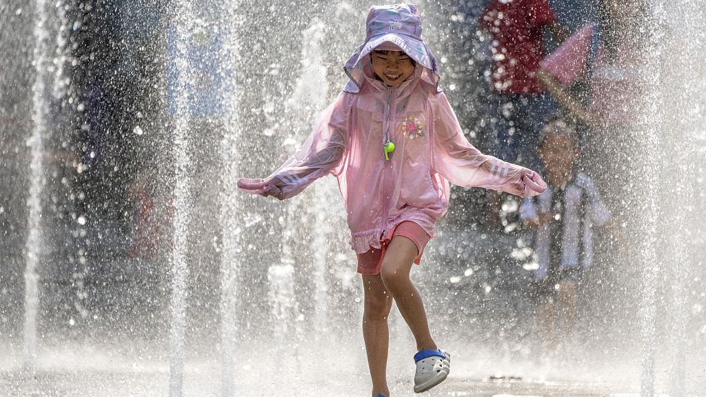 A girl plays in a fountain at a shopping mall in Beijing, China, June 23, 2023. /VCG