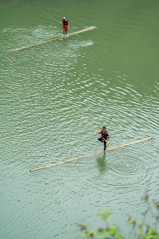 Artists perform bamboo drifting on a river in Bijie City, Guizhou Province, June 22, 2023. /CFP