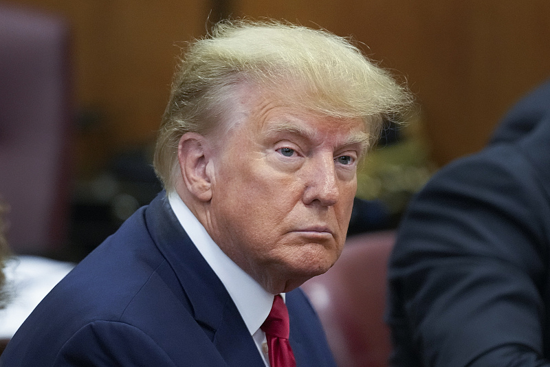 Former U.S. President Donald Trump sits at the defense table with his defense team in a Manhattan court in New York, U.S., April 4, 2023. /CFP