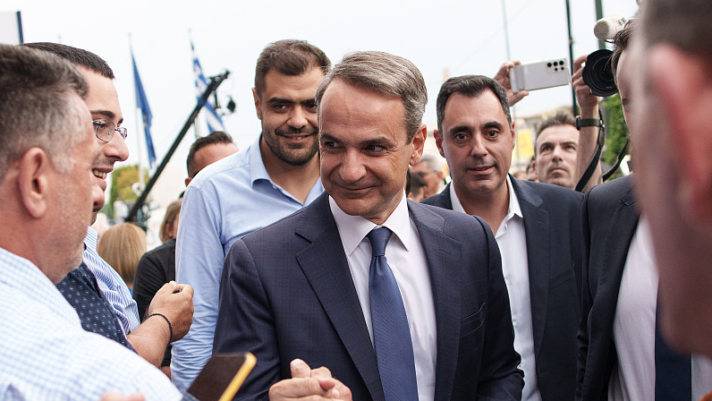 Kyriakos Mitsotakis, Greece's prime minister and leader of the New Democracy party, greets supporters as he arrives at the party headquarters during parliamentary elections in Athens, Greece, June 25, 2023. /CFP