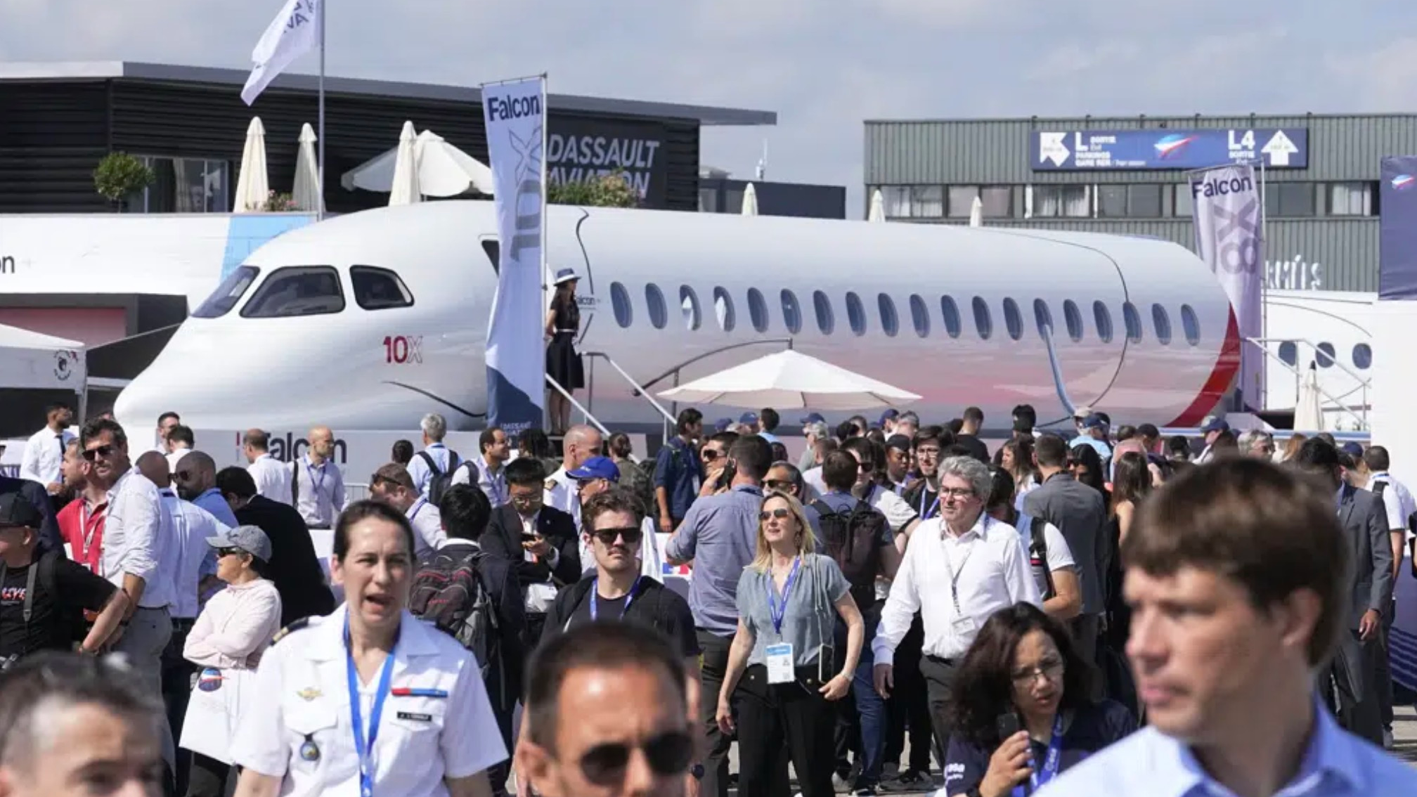 Visitors walk by a Falcon 10X prototype by the French manufacturer Dassault Aviation, at the Paris Air Show in Le Bourget, north of Paris, France, June 21, 2023. /AP