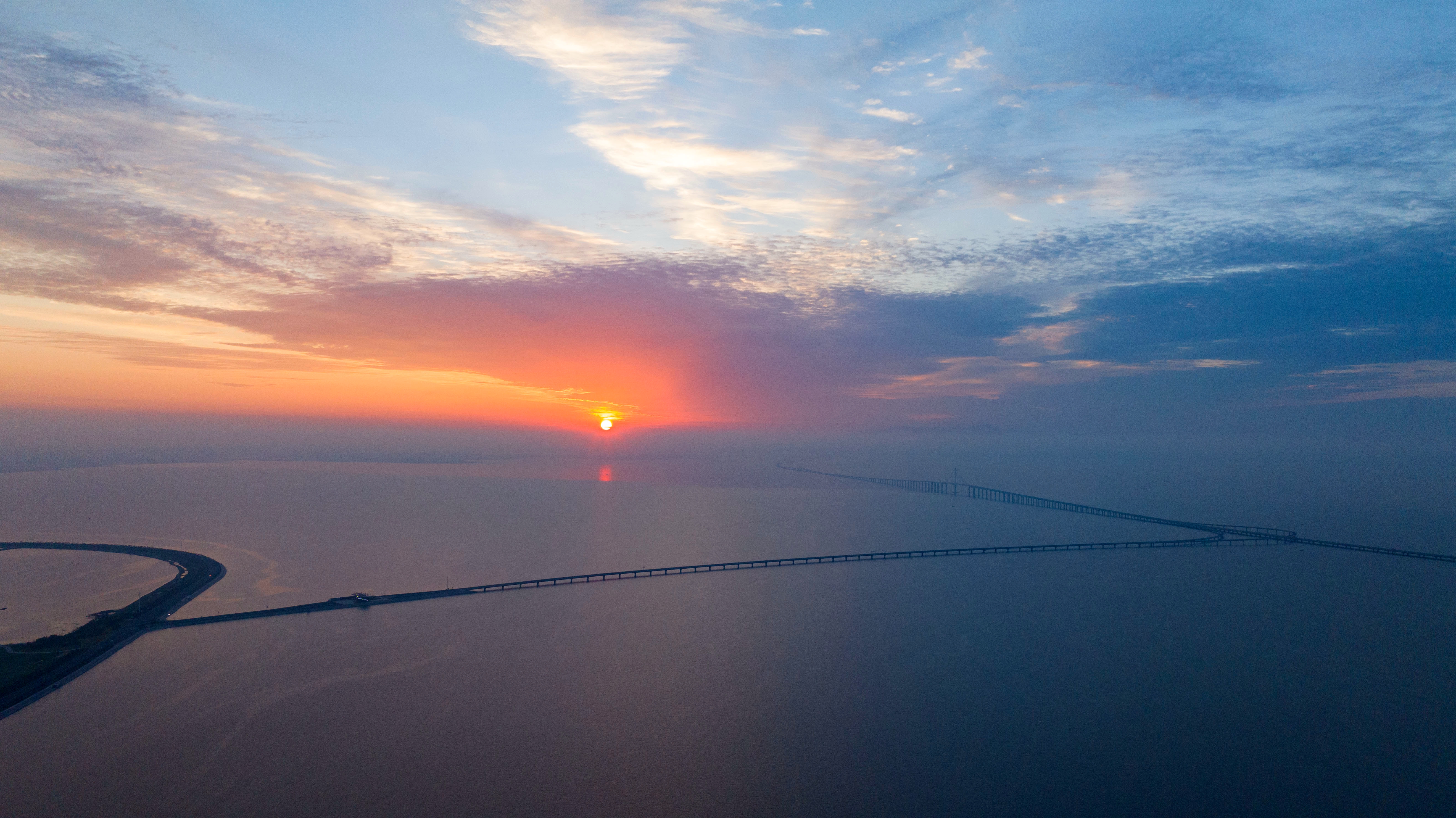 Sunrise is captured at Jiaozhou Bay in Qingdao, Shandong Province. /CNSPHOTO