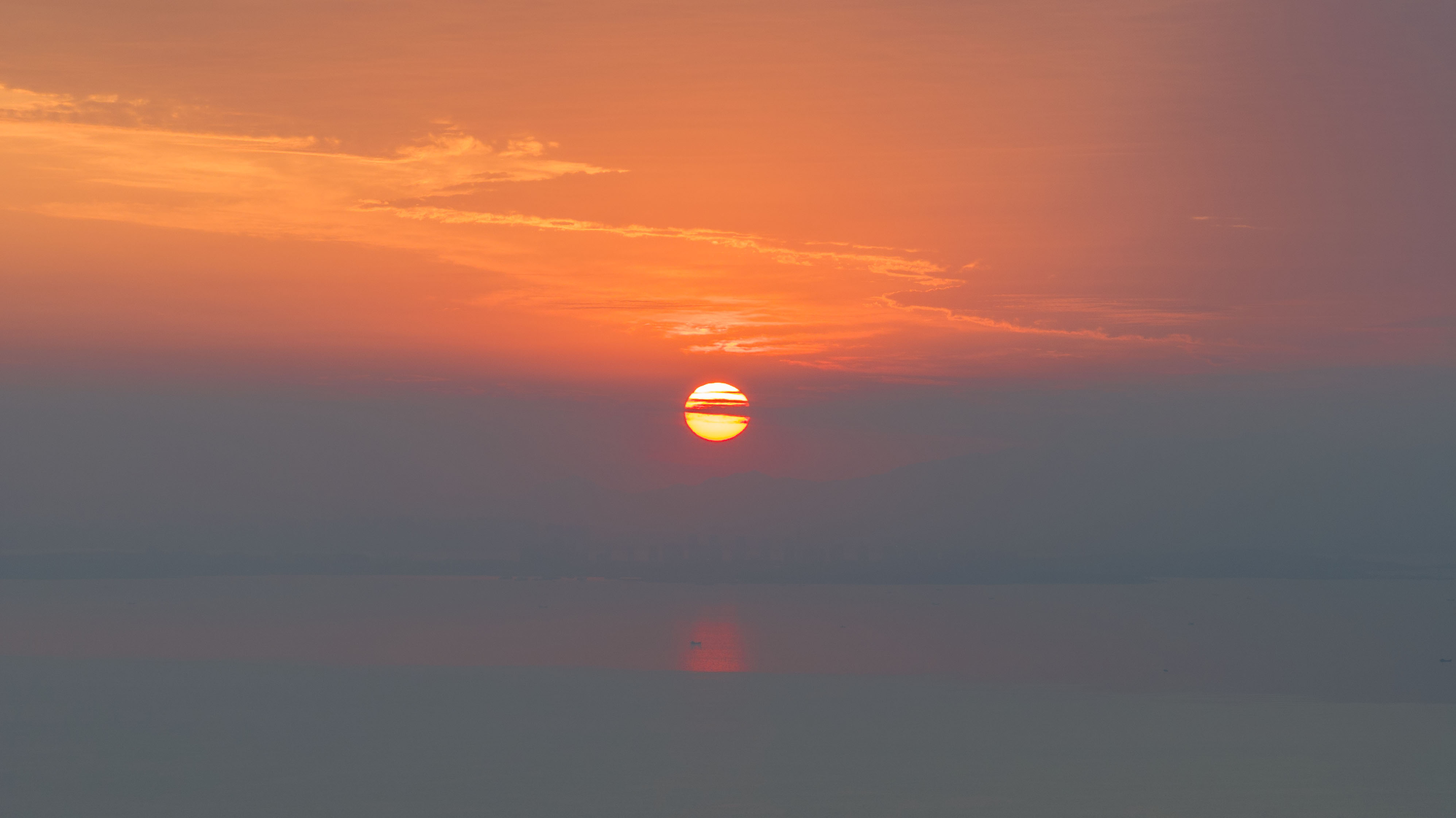 Sunrise is captured at Jiaozhou Bay in Qingdao, Shandong Province. /CNSPHOTO