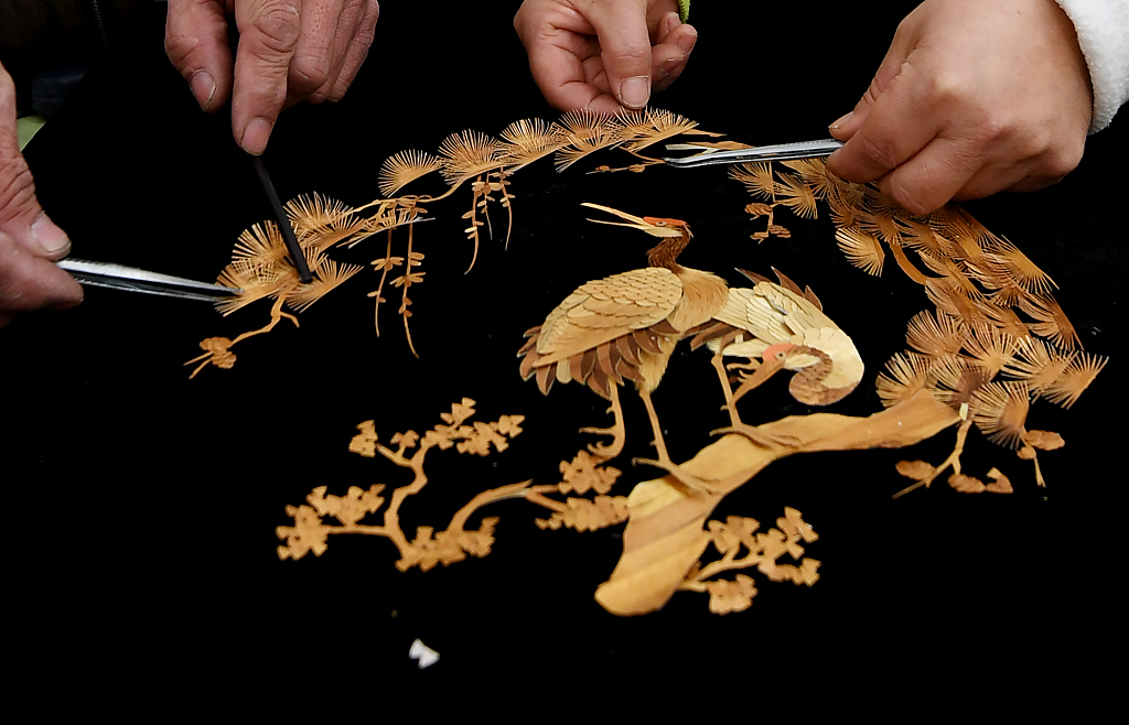 A photo shows an intricate artwork made from straw. /CFP