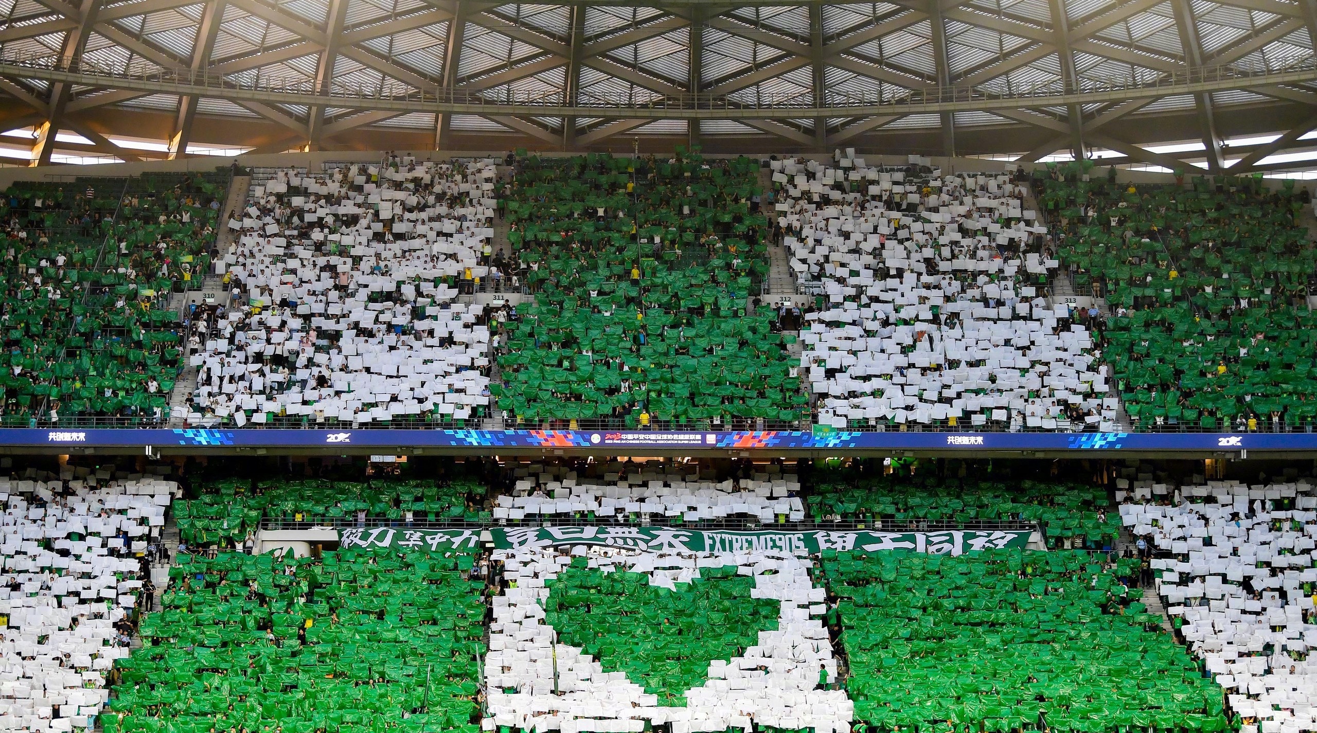 Beijing Guoan fans unfurl a huge tifo in the north end during their Chinese Super League clash with Shanghai Port at the new Workers' Stadium in Beijing, China, June 29, 2023. /Beijing Guoan