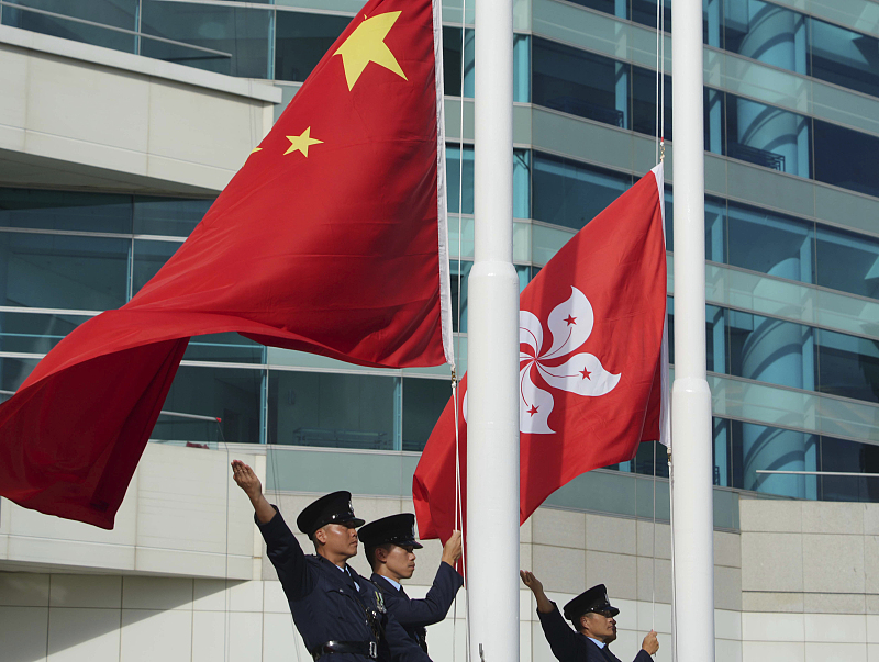 Chinese national flag and Hong Kong flag are hoisted at Golden Bauhinia Square prior to the 26th anniversary of the return of Hong Kong, June 29, 2023. /CFP