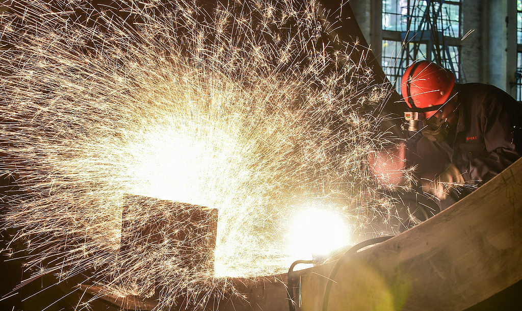 A worker welding a mill barrel in a workshop in Luoyang, Henan Province on May 16, 2023. /CFP