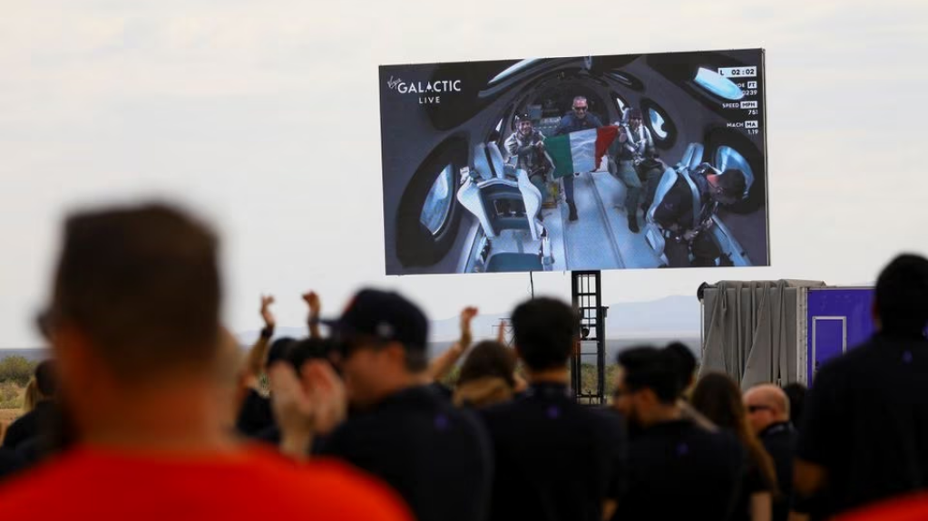Crew members of Virgin Galactic's first commercial flight to the edge of space on a screen, New Mexico, U.S., June 29, 2023. /Reuters