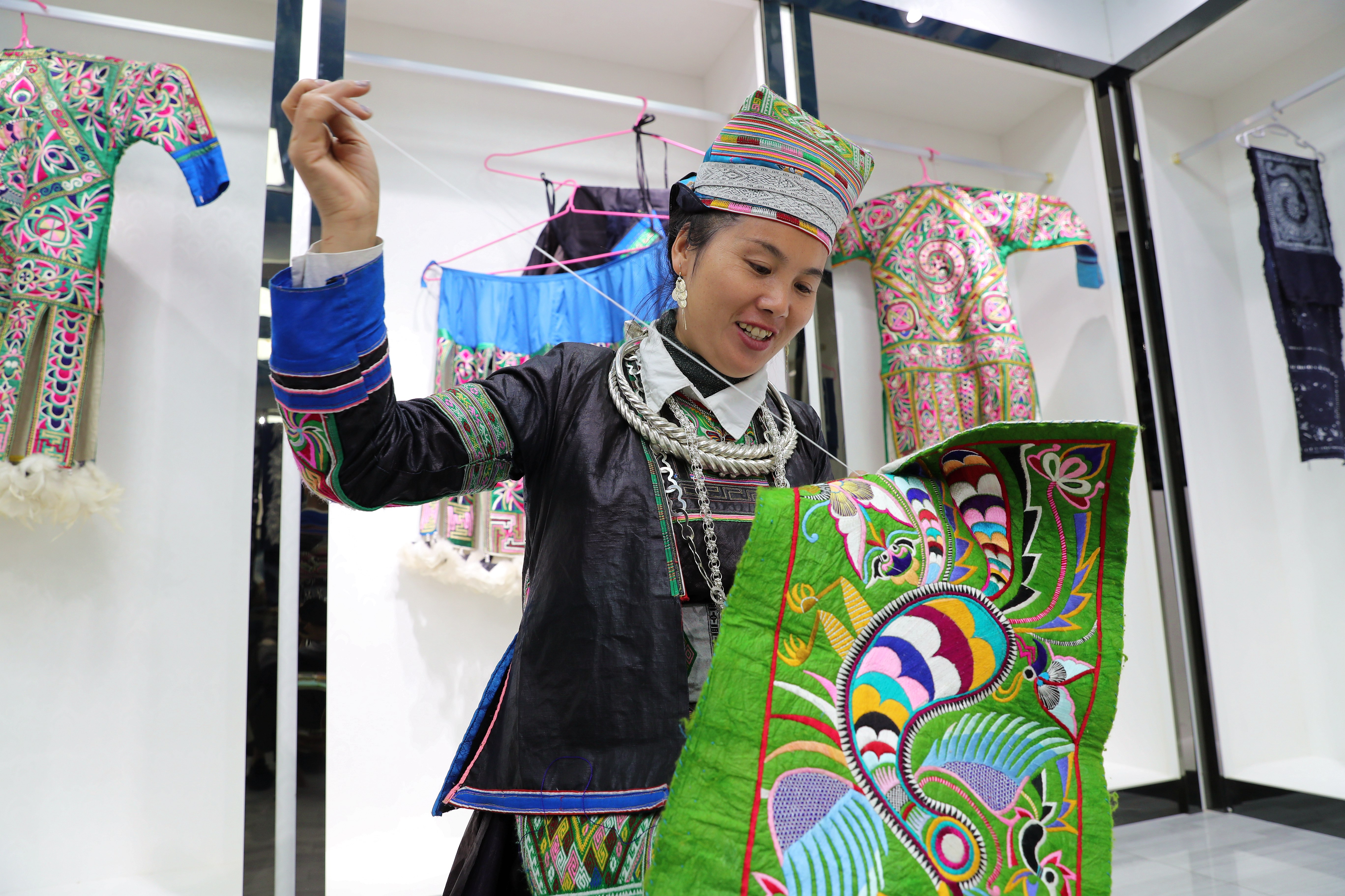 Miao women embroider at the 