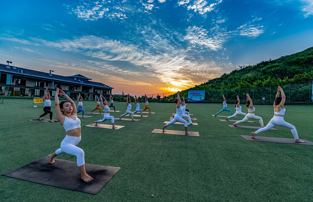 Yoga enthusiasts in Yuncheng, Shanxi Province gather in Nanshan Sports Park before sunrise to enjoy a special session of morning yoga to begin the day, July 1, 2023. /CFP