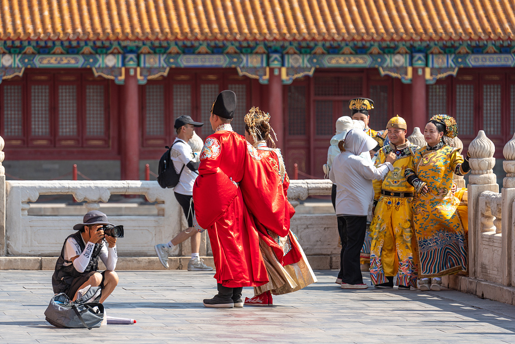 A photographer takes pictures at the Palace Museum in Beijing, June 24, 2023. /CFP