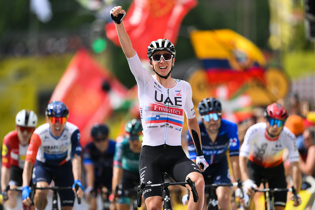 Tadej Pogacar of Slovenia and UAE Team Emirates crosses the finish line as third place and celebrates the victory during the stage one of the 110th Tour de France 2023 in Bilbao, Spain, July 1, 2023. /CFP