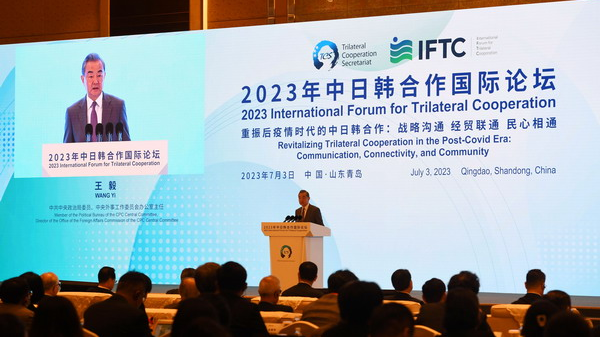 Senior Chinese diplomat Wang Yi addresses the opening ceremony of the 2023 International Forum for Trilateral Cooperation in Qingdao, east China's Shandong Province, July 3, 2023. /Chinese Foreign Ministry