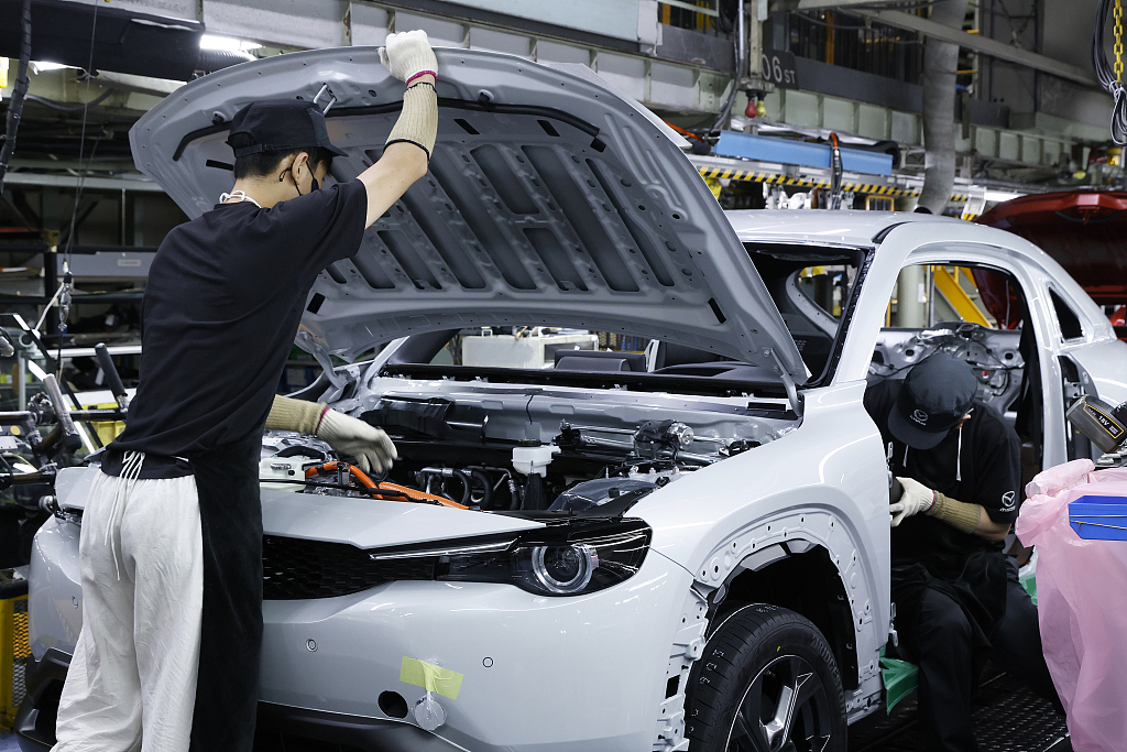 Workers assemble a vehicle on the production line in Fuchu Town, Hiroshima Prefecture, Japan, June 15, 2022. /CFP