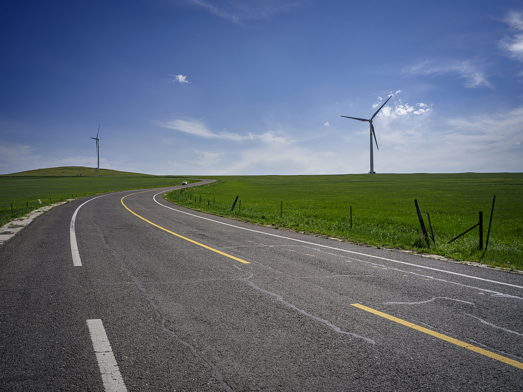Wind turbines stand tall on the vast grasslands of Hulun Buir in north China's Inner Mongolia Autonomous Region, June 26, 2023. /CFP