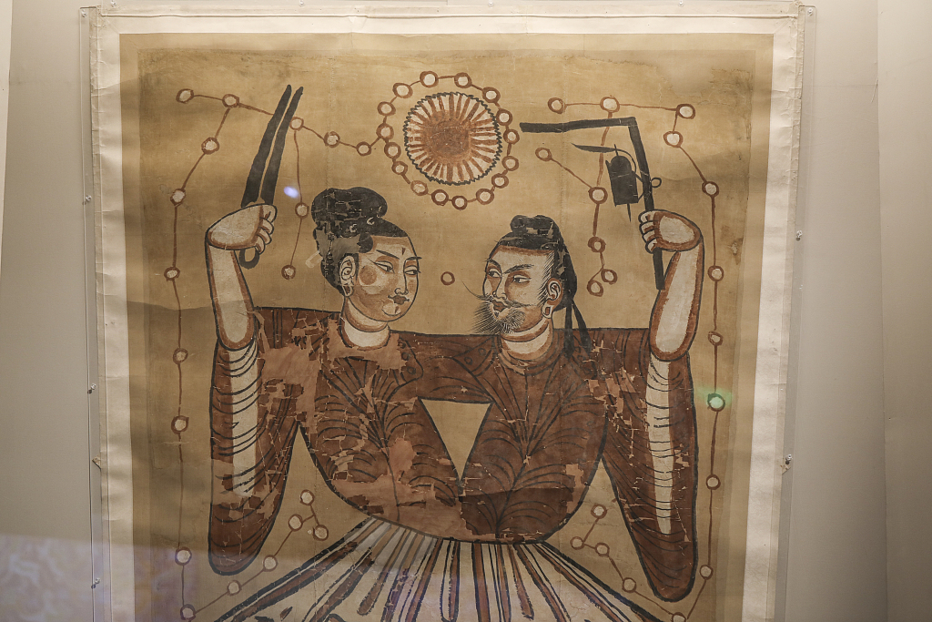 A linen cloth painting from the Tang Dynasty is displayed at a Xinjiang-themed exhibition at the National Museum in Beijing, June 21, 2023. /CFP