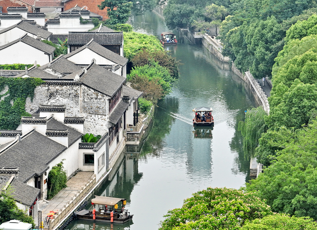 Tourists take a cruise through Qingguo Alley, a national cultural and historic block in Changzhou, Jiangsu on June 22, 2023. /CFP