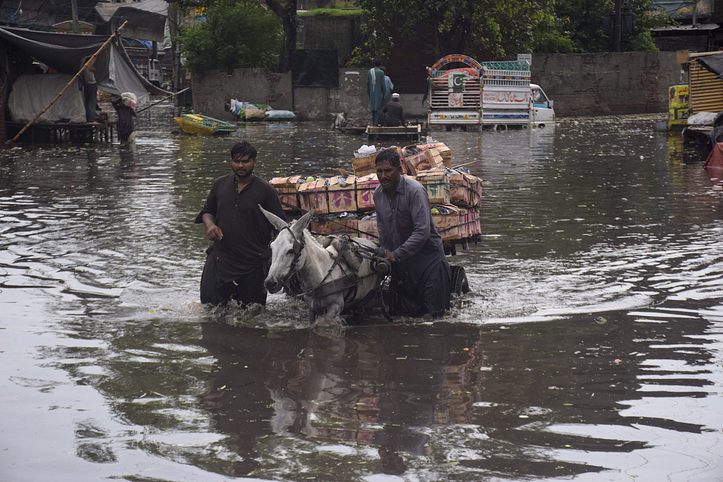 A view of flooded streets as citizens try to pass after heavy rain in Lahore, Pakistan, July 5, 2023. /CFP