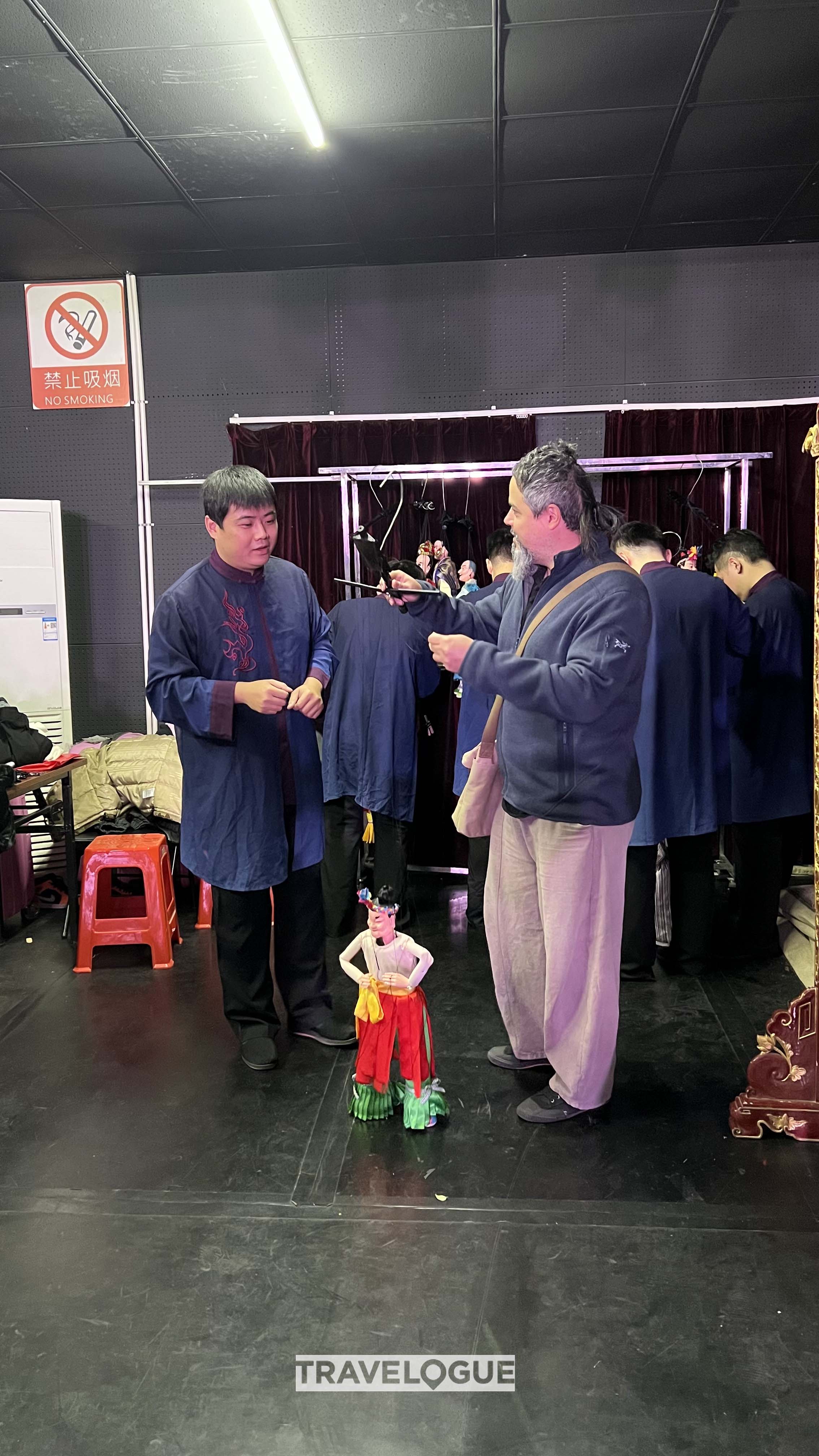 A man learns to control a puppet in Quanzhou, Fujian Province in this undated photo. /CGTN