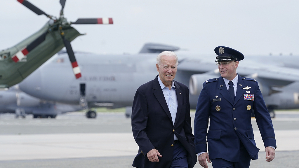 U.S. President Joe Biden, escorted by Col. William McDonald, walks to board Air Force One at Dover Air Force Base, Delaware State, July 9, 2023. /CFP 