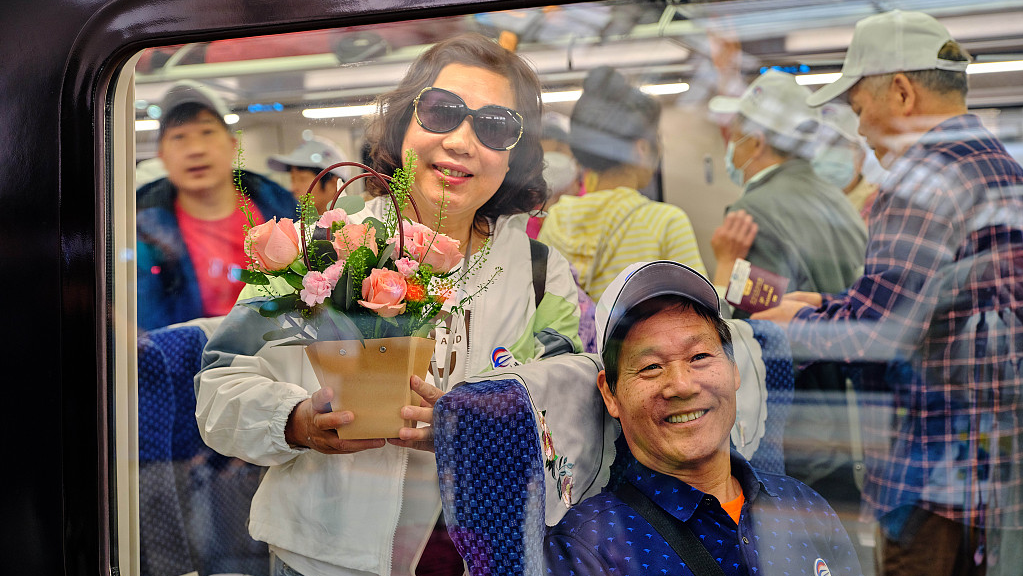 Passengers on the first cross-border passenger train of the China-Laos Railway, which departed from Kunming, capital of southwest China's Yunnan Province, heading for the Lao capital Vientiane, April 13, 2023. /CFP