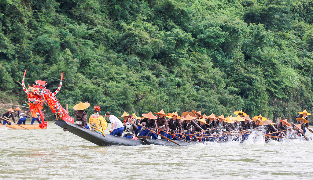 This photo taken on June 22, 2022, shows Miao villagers taking part in Canoe Dragon Boat races on the Qingshui River in southwest China's Guizhou Province. /CFP