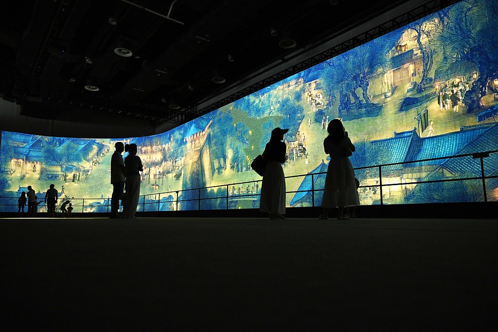 Visitors view a section of Zhang Zeduan's painting on a giant screen at the 