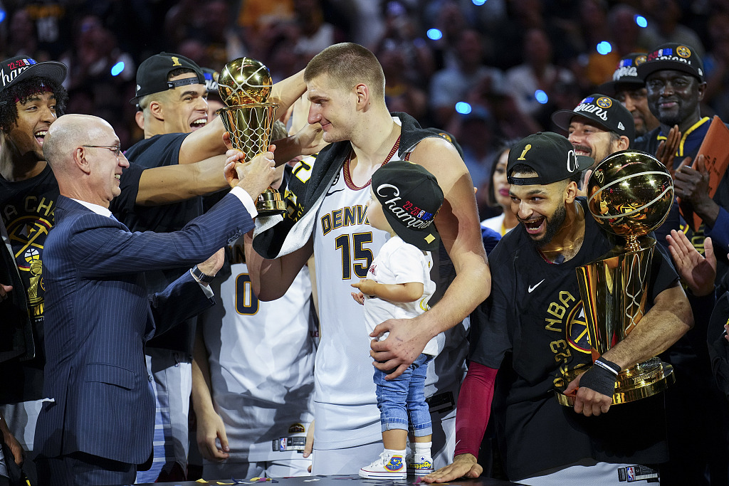 NBA Commissioner Adam Silver (L) give the Bill Russell NBA Finals Most Valuable Player Trophy to Nikola Jokic (C) of the Denver Nuggets after they defeat the Miami Heat 94-89 in Game 5 of the series at Ball Arena in Denver, Colorado, June 12, 2023. /CFP