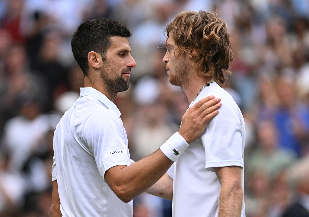 Novak Djokovic (L) and Andrey Rublev greet each other at the net after their match during day nine of The Championships, Wimbledon, at All England Lawn Tennis and Croquet Club in London, England. July 11, 2023. /CFP