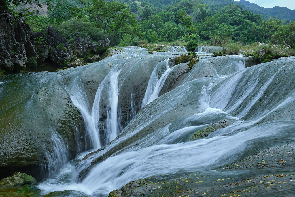 Tourists admire the majestic roar of the Huangguoshu Waterfall in Anshun, Guizhou on July 3, 2023. /CFP