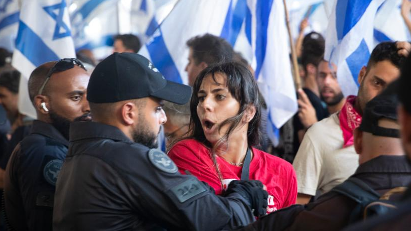 A woman confronts police during a protest against the government's plan to overhaul the judiciary at Ben Gurion Airport near Tel Aviv, Israel, July 11, 2023. /Xinhua