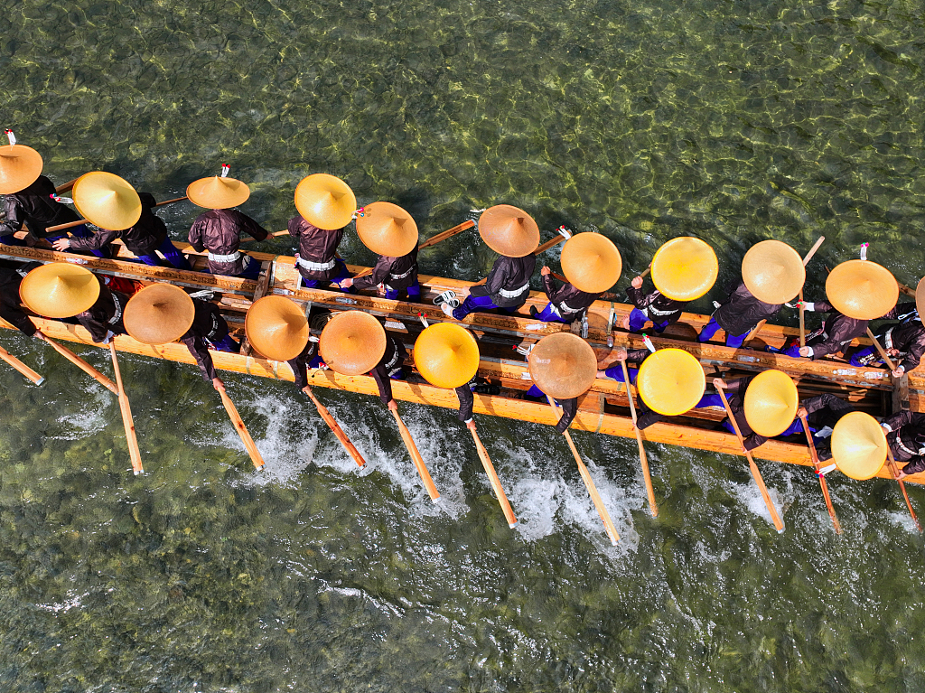 Photo taken on July 22, 2023 shows the Miao ethnic group celebrating the Canoe Dragon Boat Festival in Shidong Town, Taijiang County, Guizhou. /CFP