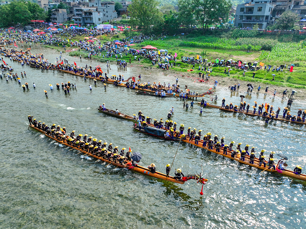 Photo taken on July 22, 2023 shows the Miao ethnic group celebrating the Canoe Dragon Boat Festival in Shidong Town, Taijiang County, Guizhou. /CFP