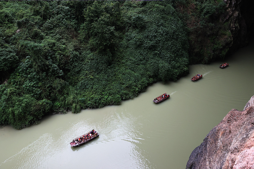 This photo taken on July 13, 2023 shows that people embarked on boat ride through Puhua River in Chongqing. /CFP