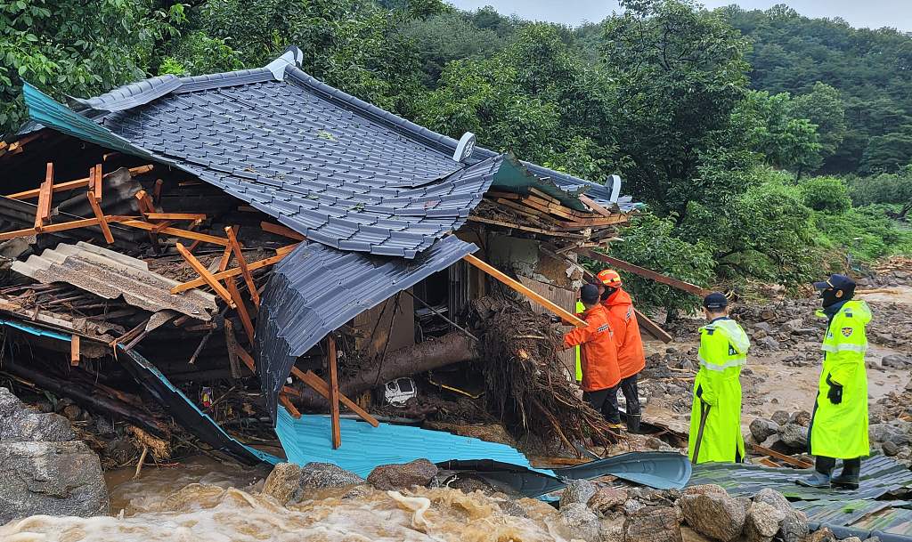 South Korean emergency workers search for survivors at a house destroyed by flood waters after heavy rains in Yecheon, South Korea, July 15, 2023. /AFP via Gyeongbuk Fire Service Headquarters