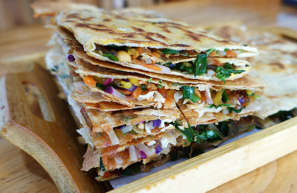 The jianbing, or fried pancake, is hailed as one of China's most popular on-the-go street snacks, which is said to have originated in east China's Shandong Province. /CFP