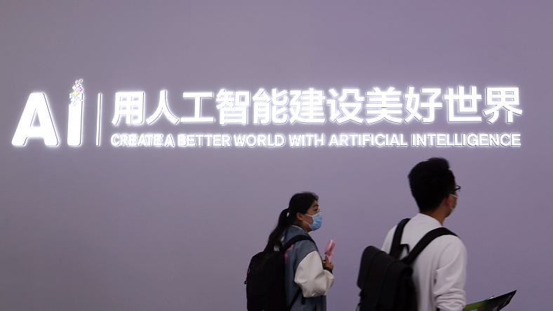 Attendees walk past a company logo at a consumer electronics expo in Shanghai, April 27, 2023. /CFP