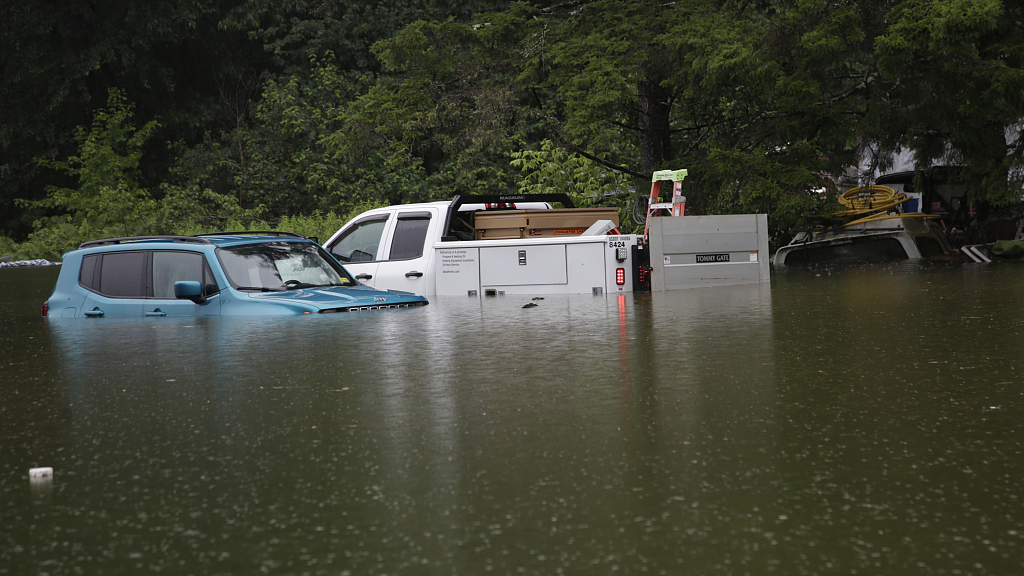 Floodwaters rise in Bridgewater, Vermont, July 10, 2023, submerging parked vehicles and threatening homes near the Ottauquechee River. /CFP