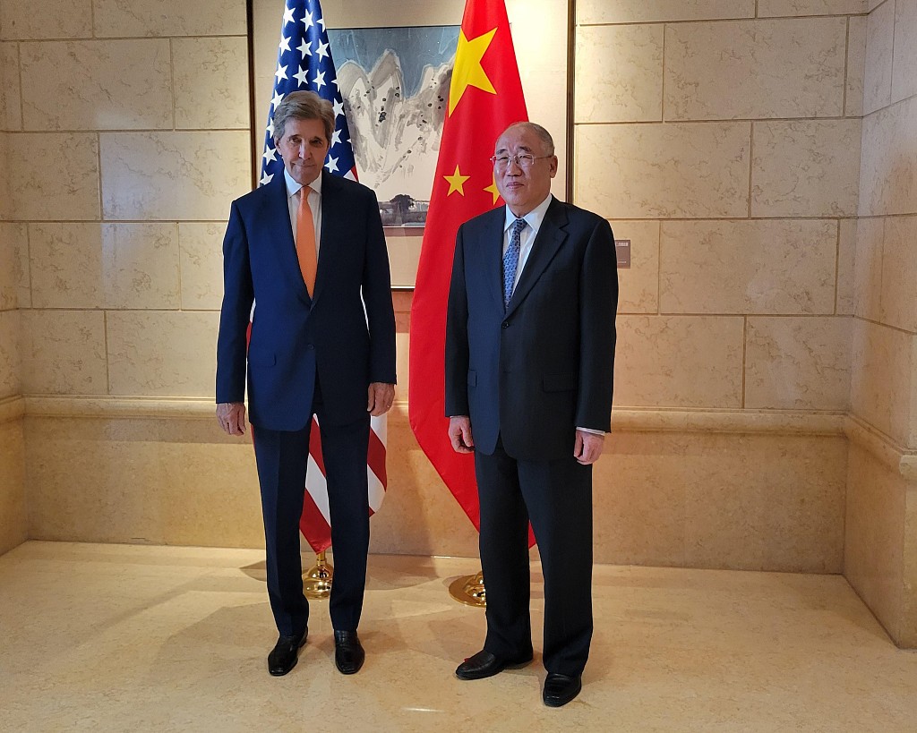 Xie Zhenhua (right), China's special envoy for climate change, greets U.S. Presidential Special Envoy for Climate John Kerry ahead of talks in Beijing, China, July 17, 2023. /CFP