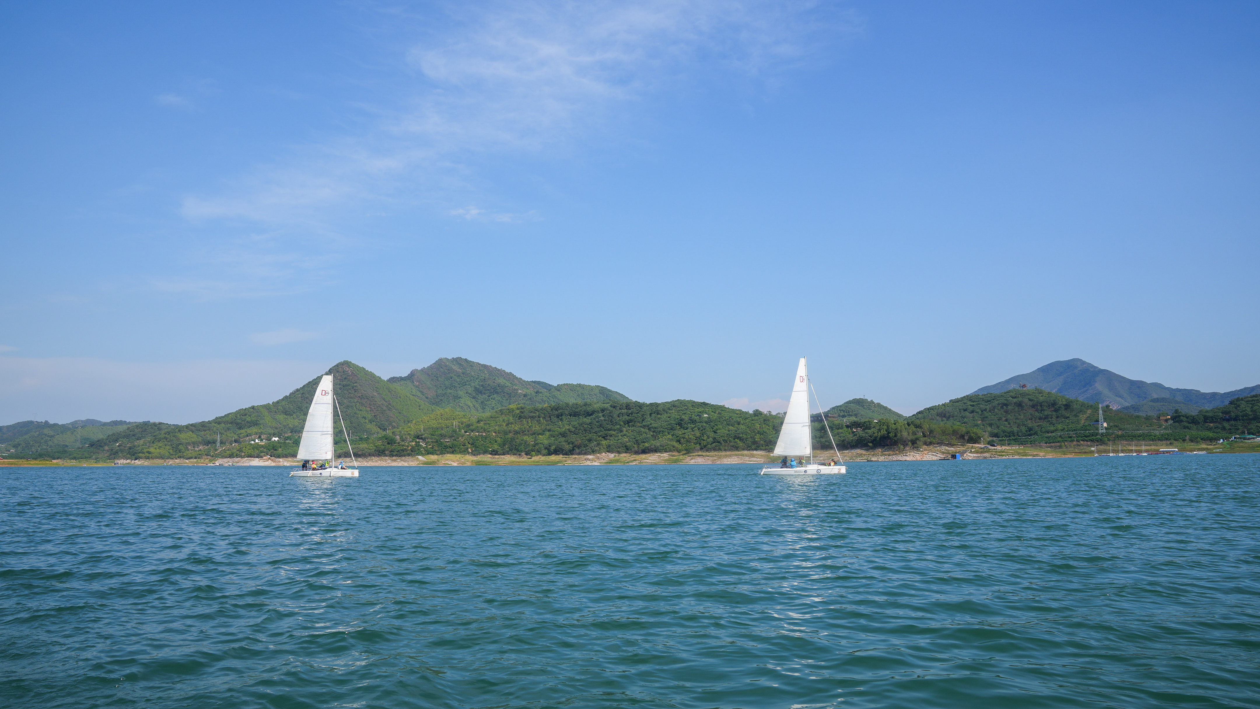 Sailboats ride the waves on Beijing's Jinhai Lake