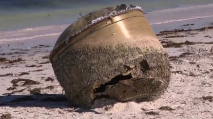 A view of a cylindrical object about the size of a small car that washed up on a remote Australian beach. /AP