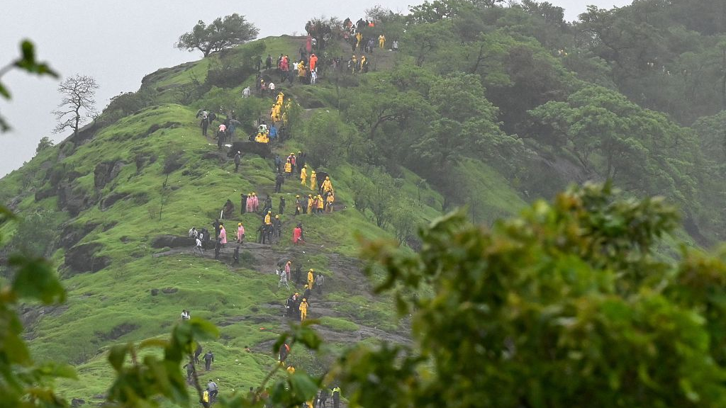 Rescue workers and villagers are seen on the hillock leading up to the site of the landslide at Irshalwadi village, Maharashtra state, India, July 20, 2023. /CFP