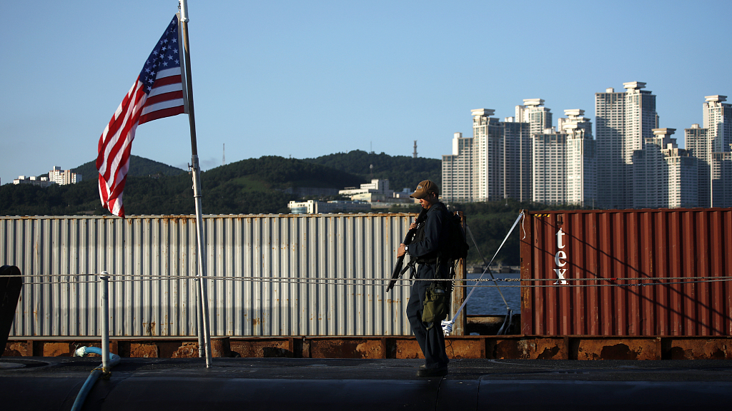 A crew member patrols on the deck of the USS Kentucky, a U.S. nuclear-armed submarine, anchored at the Busan Naval Base in Busan, Republic of Korea, July 19, 2023. /CFP