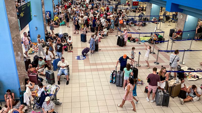 Live: Tourists flock to Rhodes airport in Greece as wildfire forces thousands to flee