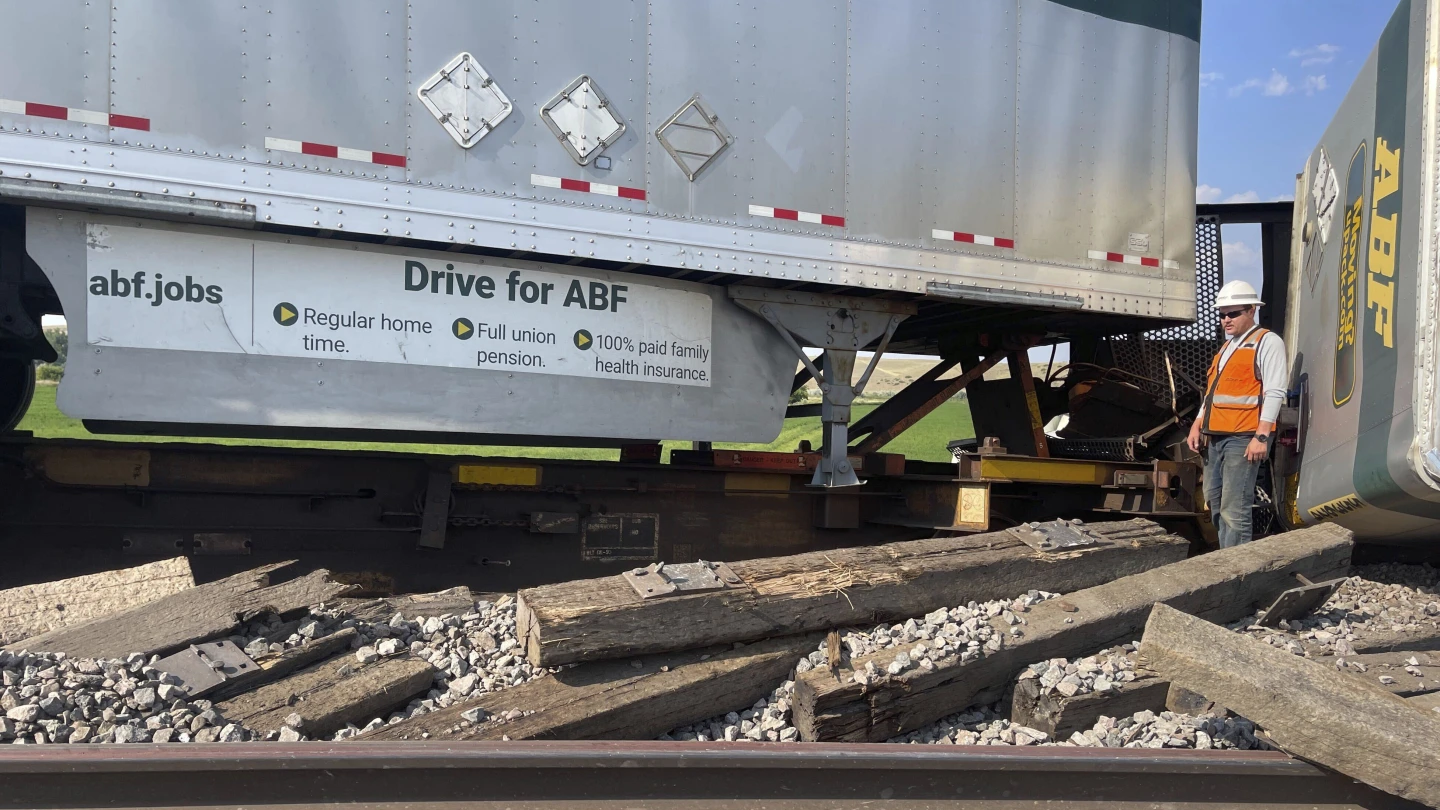 A railroad worker stands among derailed freight cars from a BNSF Railway train that derailed east of Havre, Montana, U.S., July 21, 2023. /AP