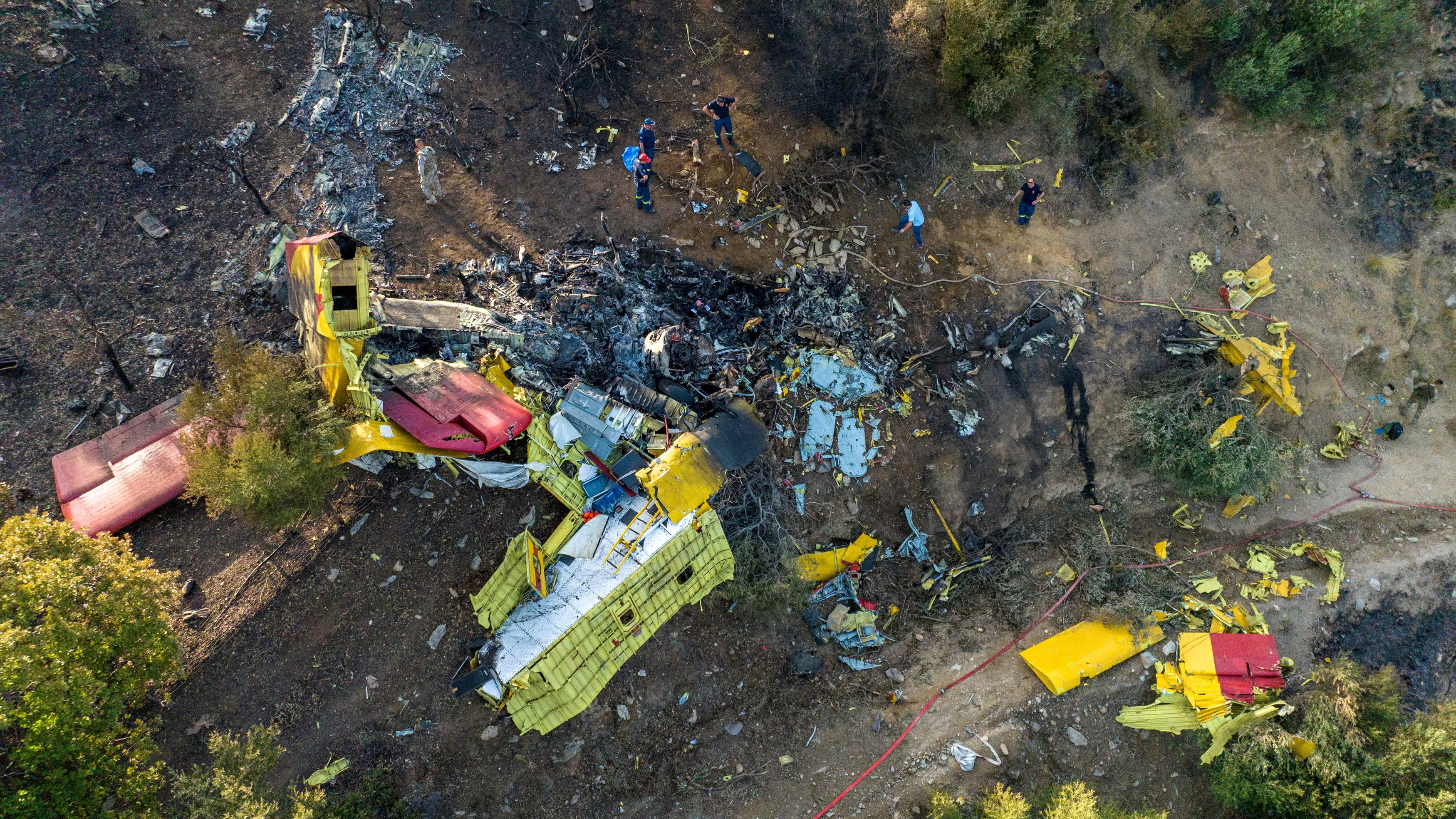 Rescuers operate at the site where a firefighting plane crashed after a water drop as a wildfire burns in Karystos on the island of Evia, Greece, July 25, 2023. /Reuters