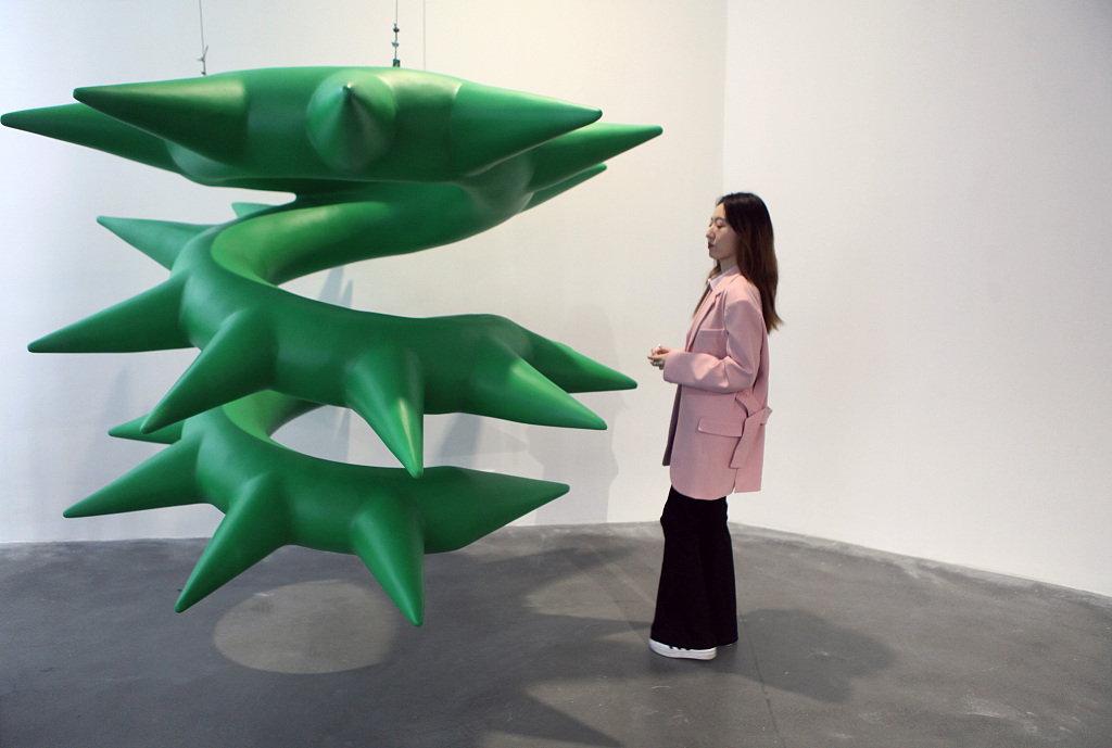 This photo taken on April 28, 2023 shows a visitor interacting with an art installation by French artist Cyril Lancelin at the K11 Art Space in Liaoning Province's Shenyang. /CFP