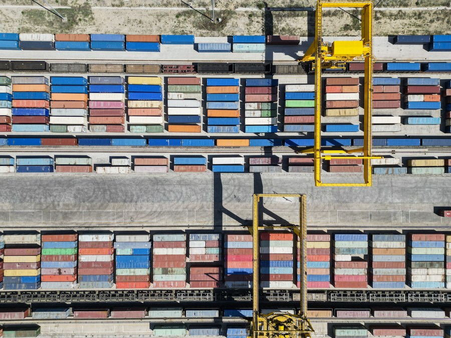 An aerial photo shows a crane loading containers at a railway port in Horgos, northwest China's Xinjiang Uygur Autonomous Region, May 11, 2023. /Xinhua