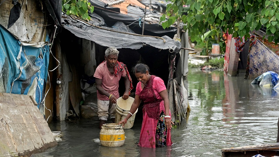 People walk through a flooded ghetto after monsoon rains in Amritsar, India, July 24, 2023. /CFP